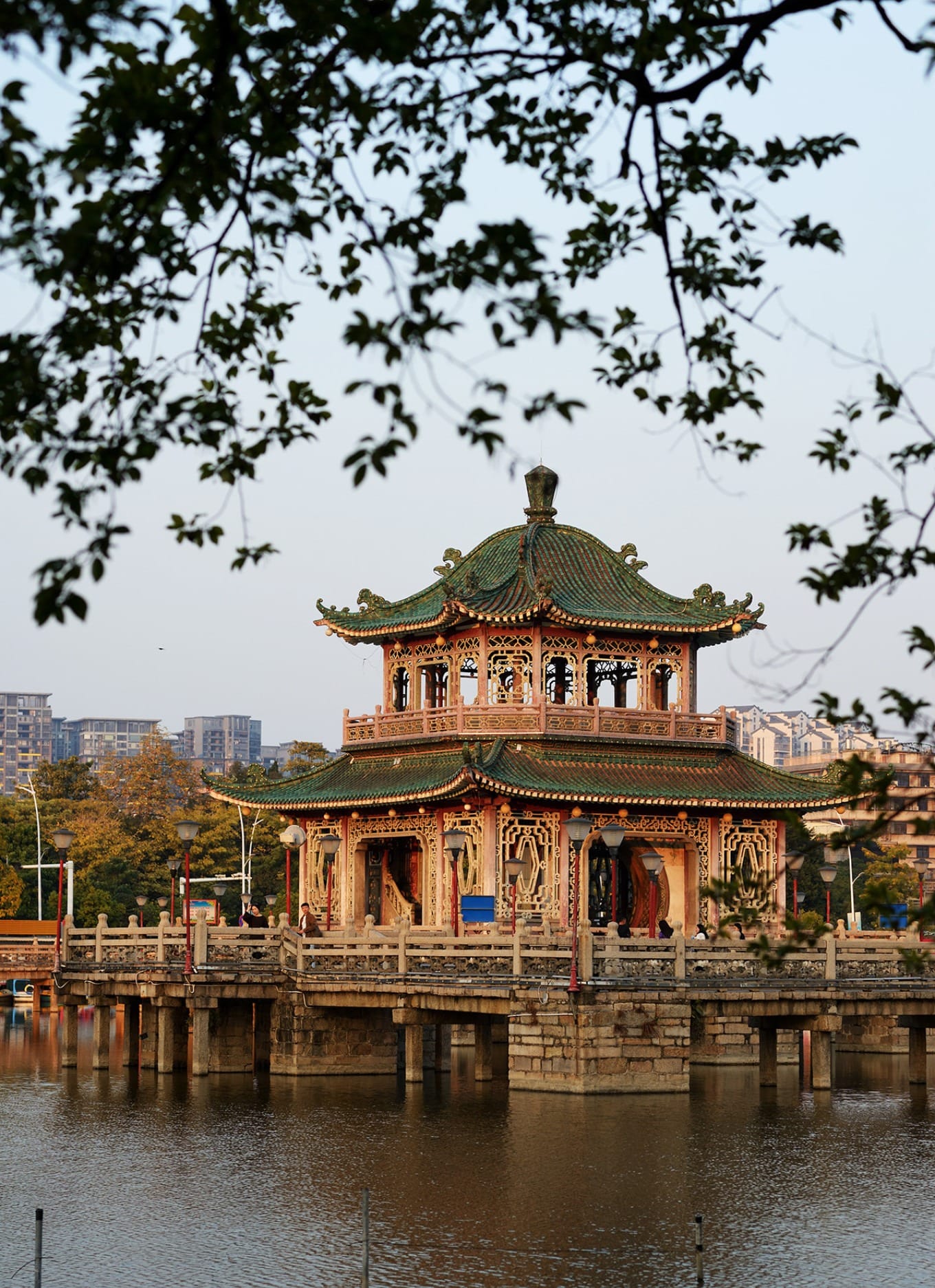 Serene lake view with the double-story pavilion reflected in calm waters