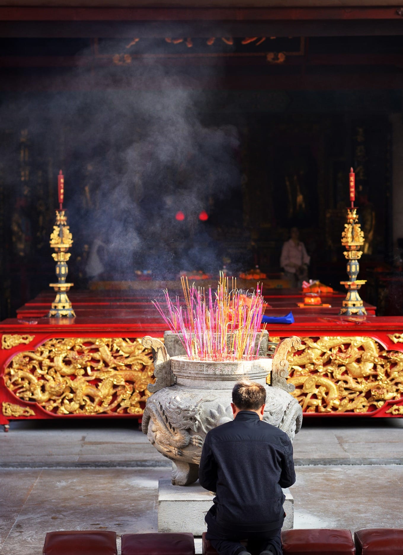 Worship pavilion with burning incense sticks in bronze incense burner