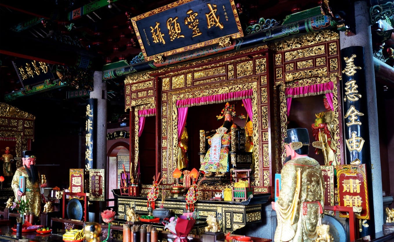 Interior of the main hall with golden decorations and deity niches