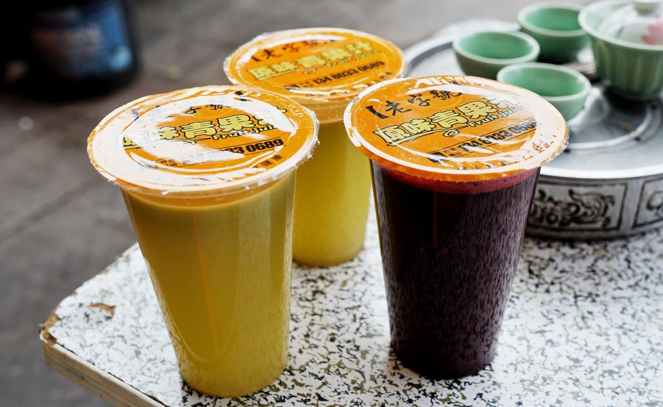 Shop owner pouring extra juice for a customer