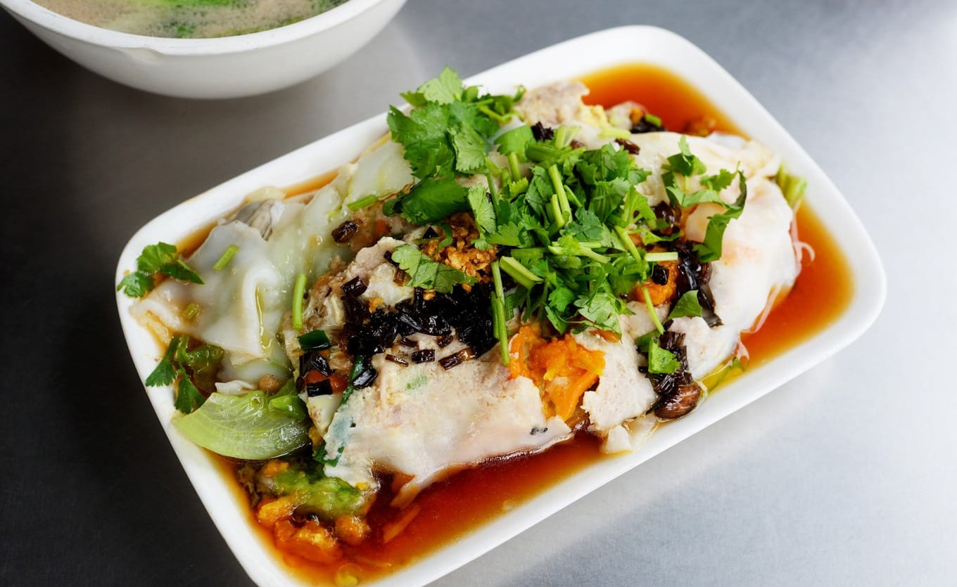 Close-up of steamed rice rolls with mixed fillings showing translucent rice wrapper