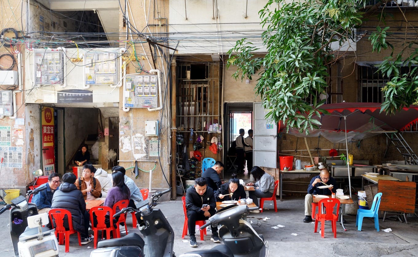Outdoor sidewalk seating at Guangda Cabbage Rice Rolls restaurant in Puning