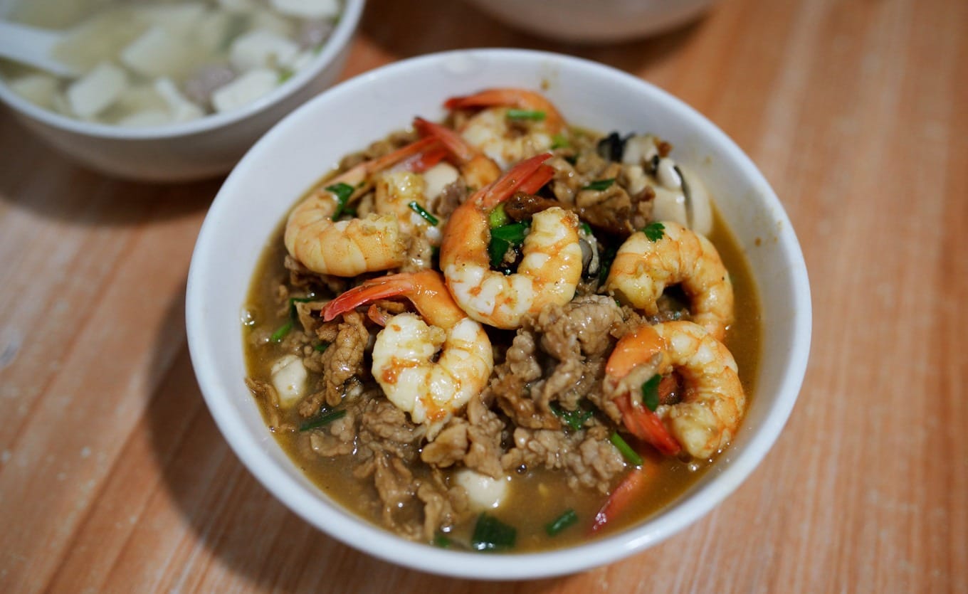 Bowl of seafood lo mein topped with generous shrimp oysters and pork