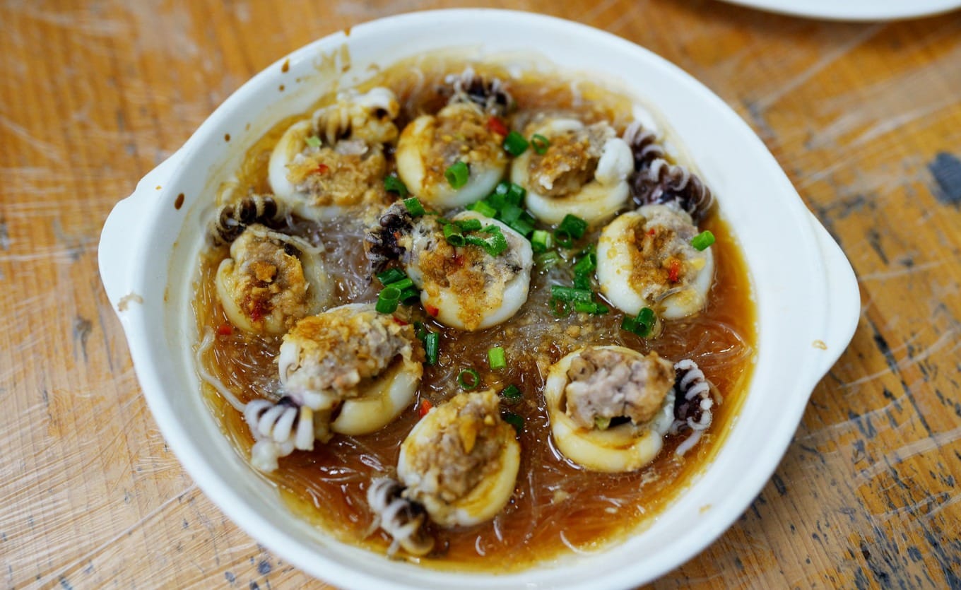 Steamed squid with garlic and vermicelli noodles arranged on a round dish