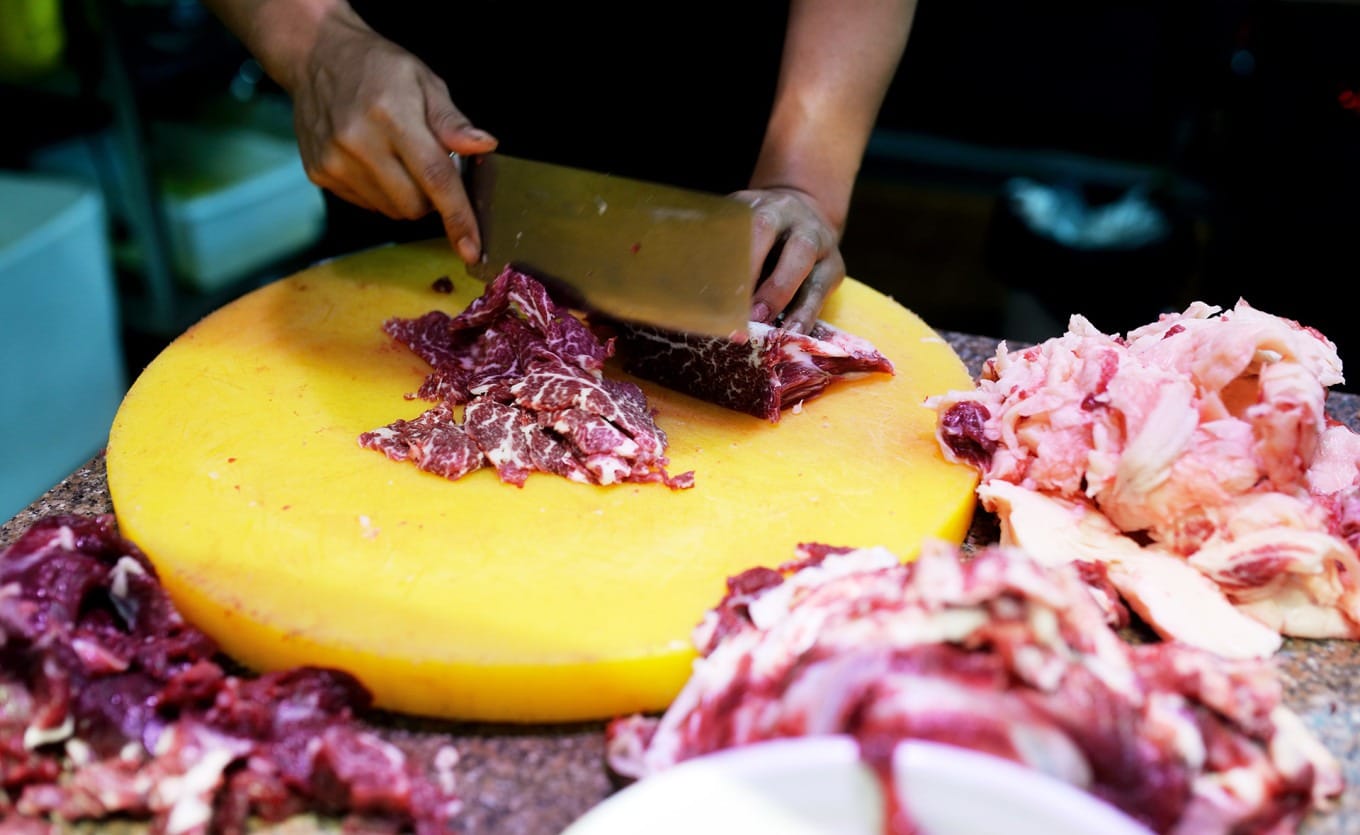 Interior dining hall of Zhuangxiong beef hot pot restaurant with tables and boiling pots