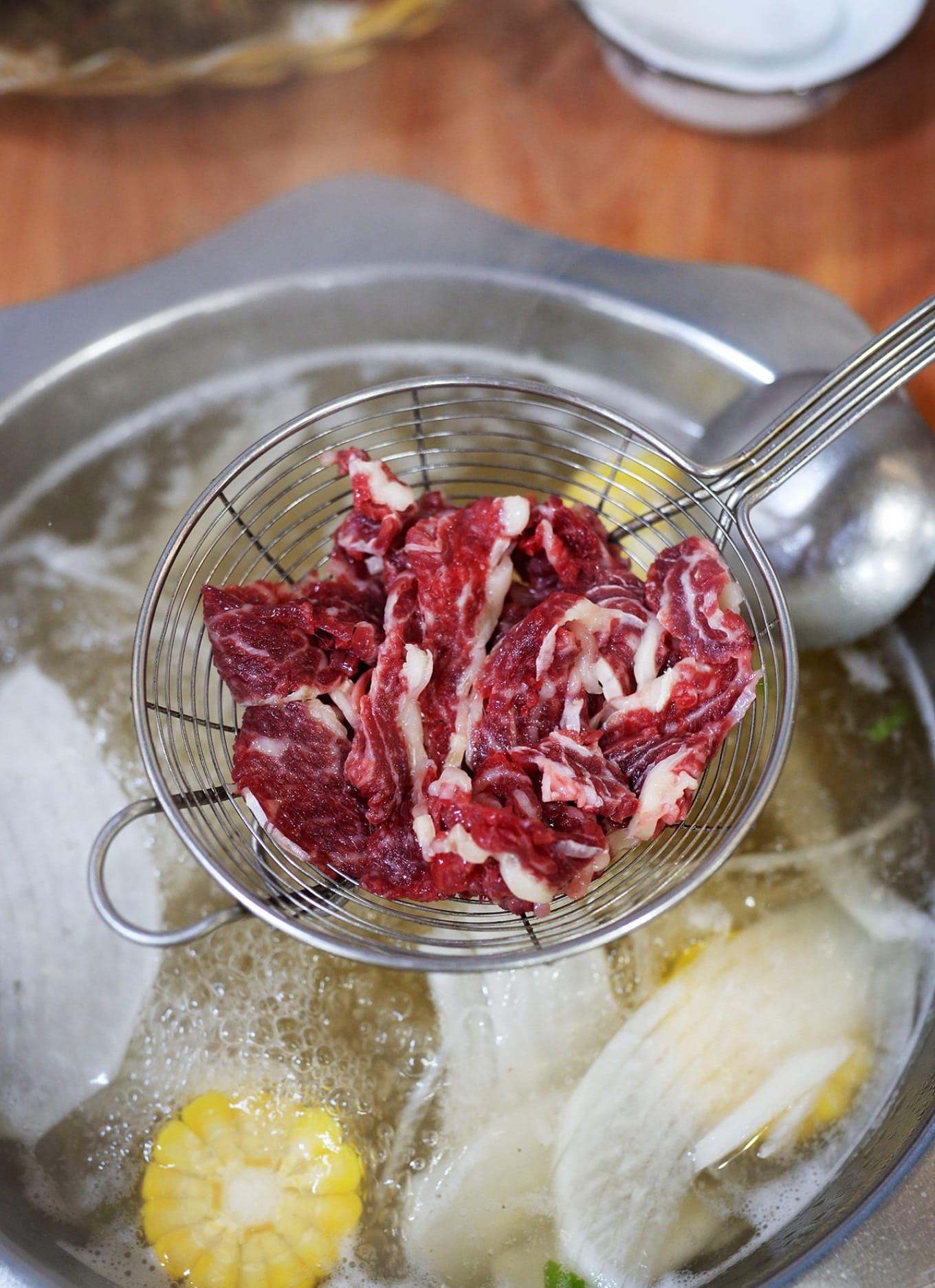 Thinly sliced Dianglong rib eye beef with visible marbled fat strips