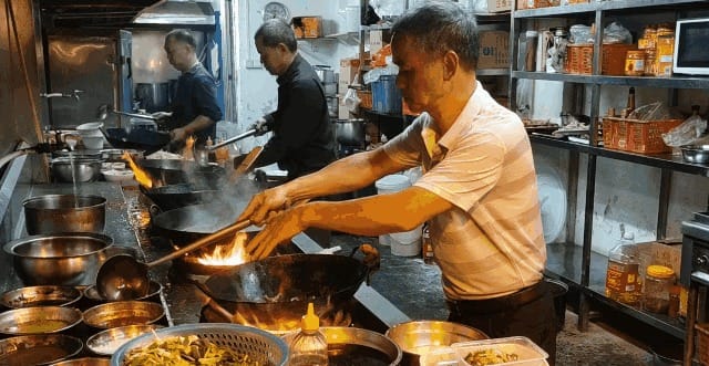 Diners selecting dishes from the busy food counter