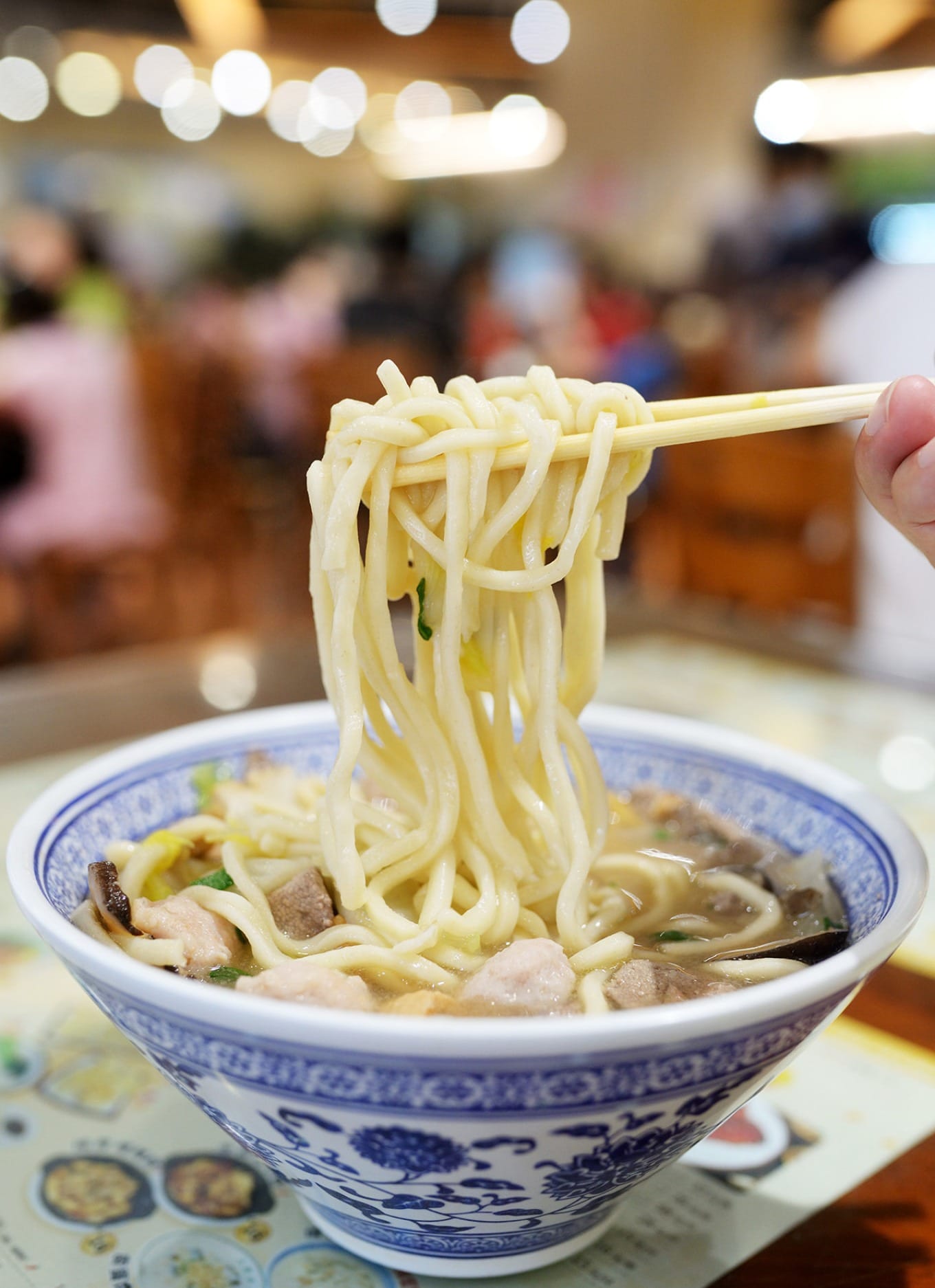 Close-up of the savory wet noodles with a rich broth