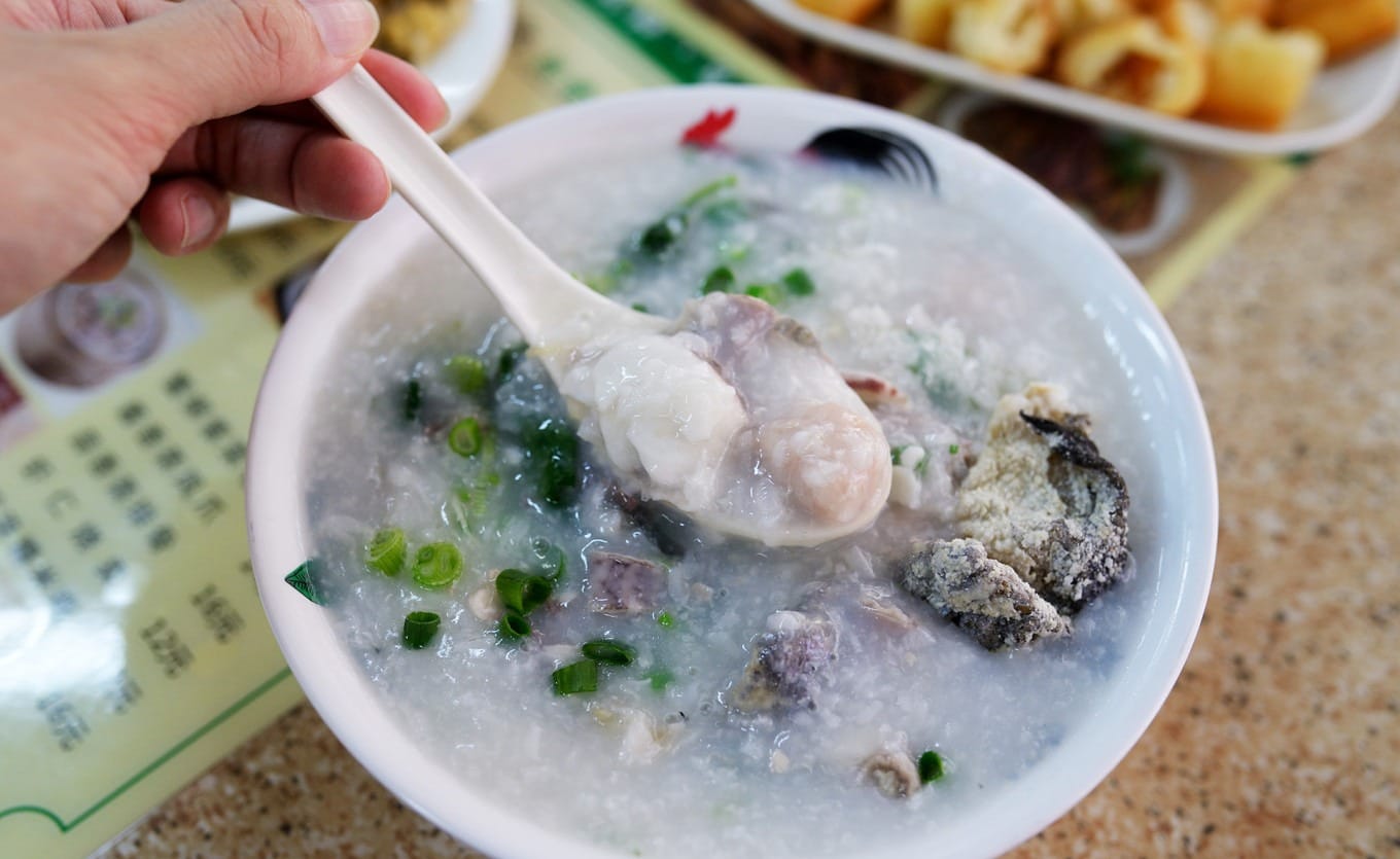 Daojiao meatballs and other ingredients in a bowl of porridge