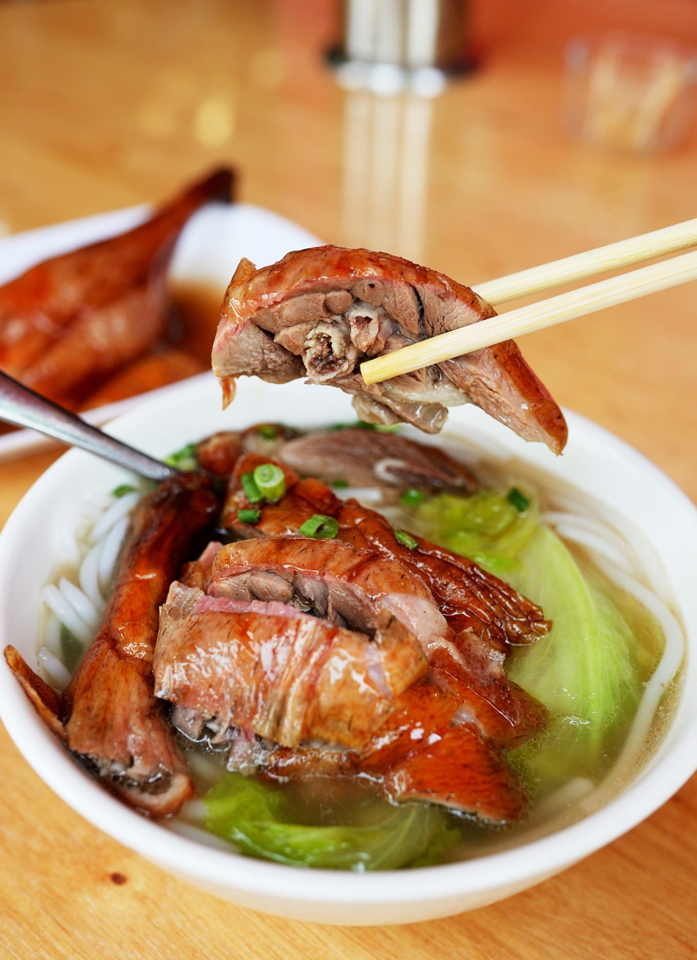A plate of Laifen topped with succulent goose leg