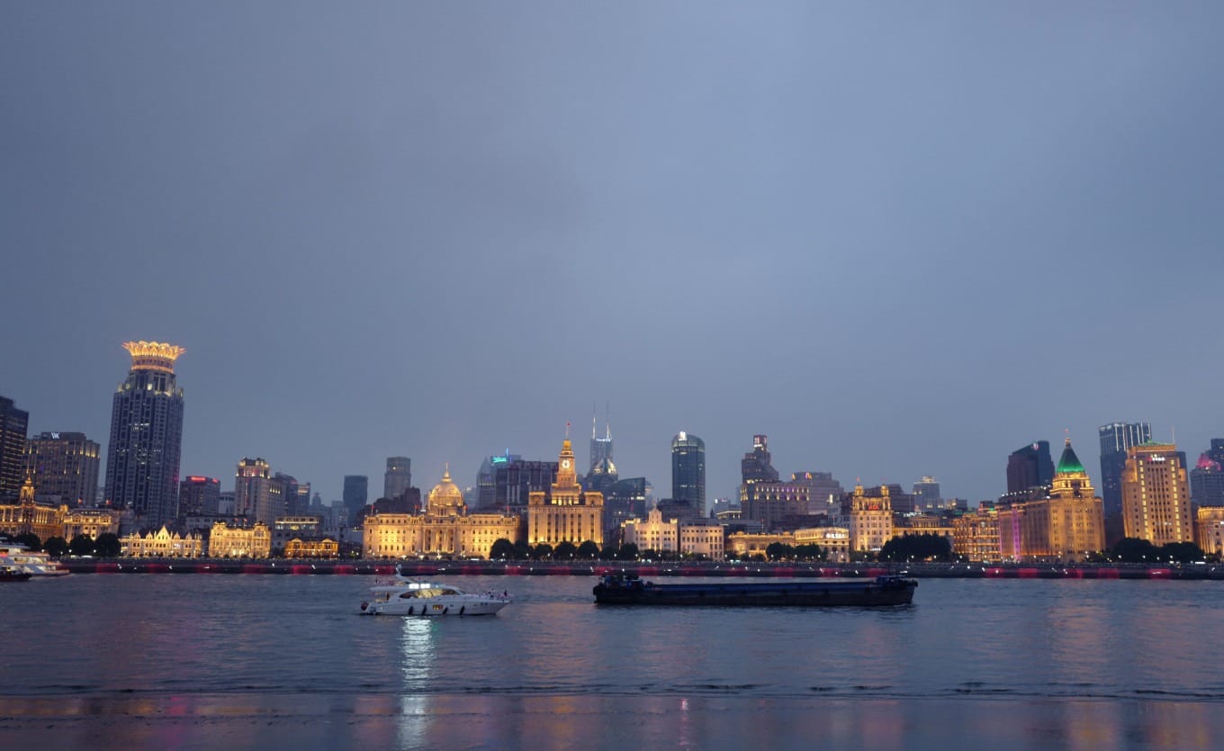A classic view of the historic Bund waterfront with colonial-era buildings lining the Huangpu River
