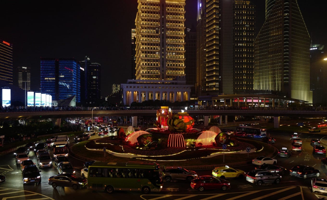 The Oriental Pearl Tower illuminated at dusk against the Shanghai skyline