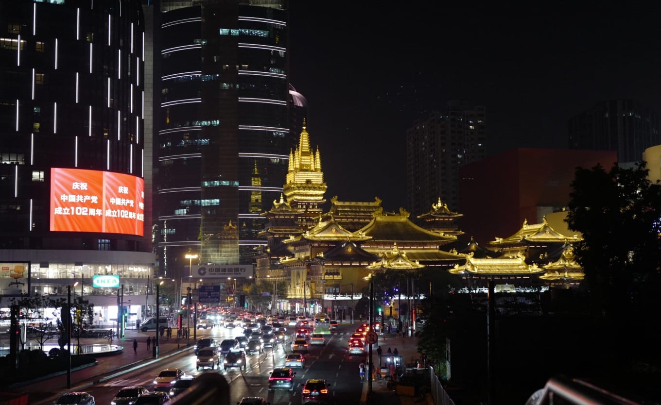 A serene traditional Chinese garden with pavilions, ponds, and lush greenery