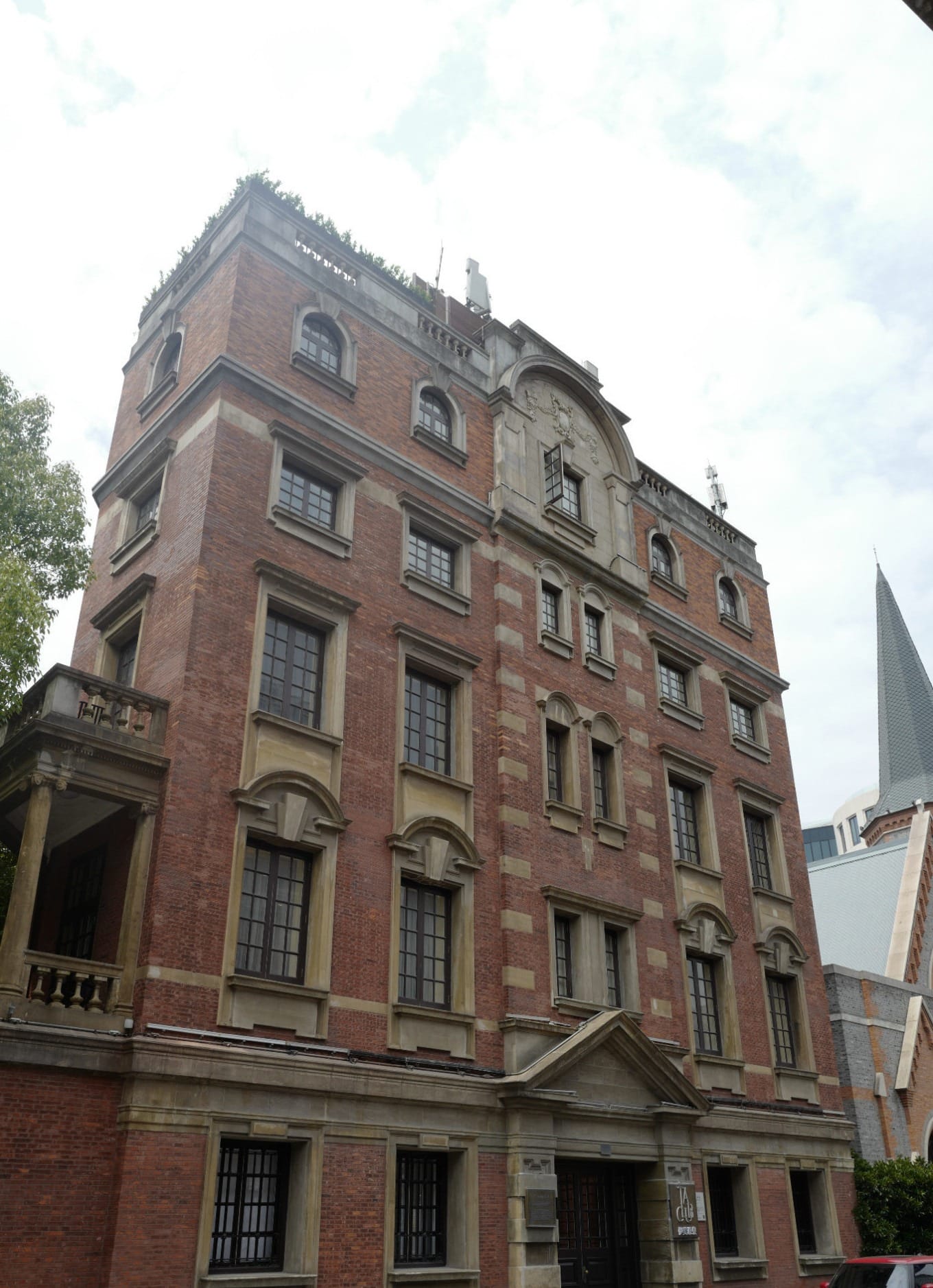 Missionary Apartments building with red brick facade and classical columns