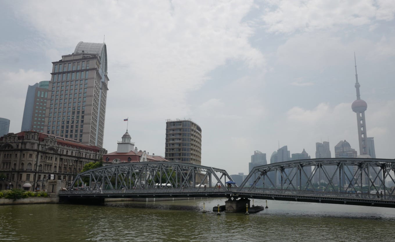 Waibaidu Bridge spanning Suzhou Creek with historic buildings in background