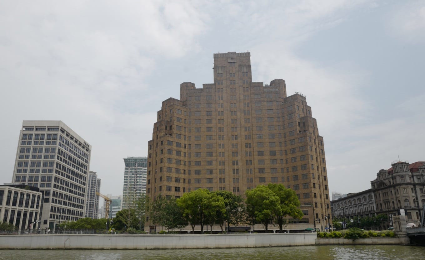 Detailed view of the Shanghai Mansions' architectural features and waterfront location