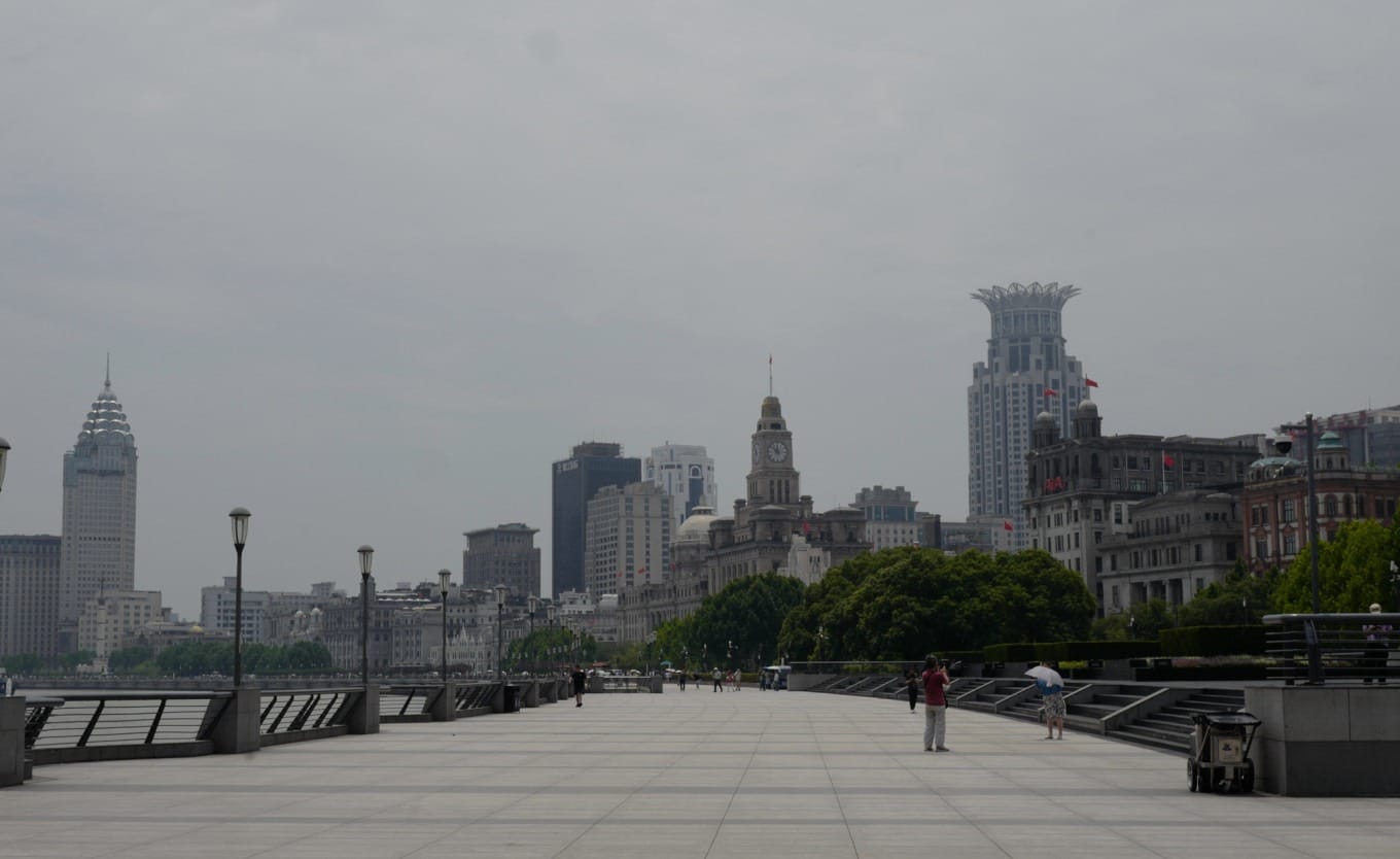 A wide-angle view of The Bund's historic buildings along the Huangpu River