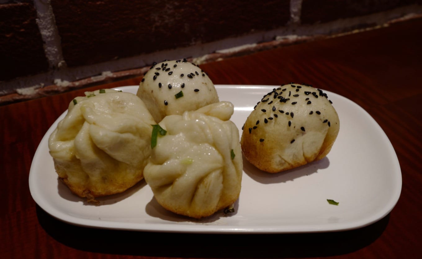 Close-up of Da Hu Chun's shengjianbao showing crispy bottom and juicy filling