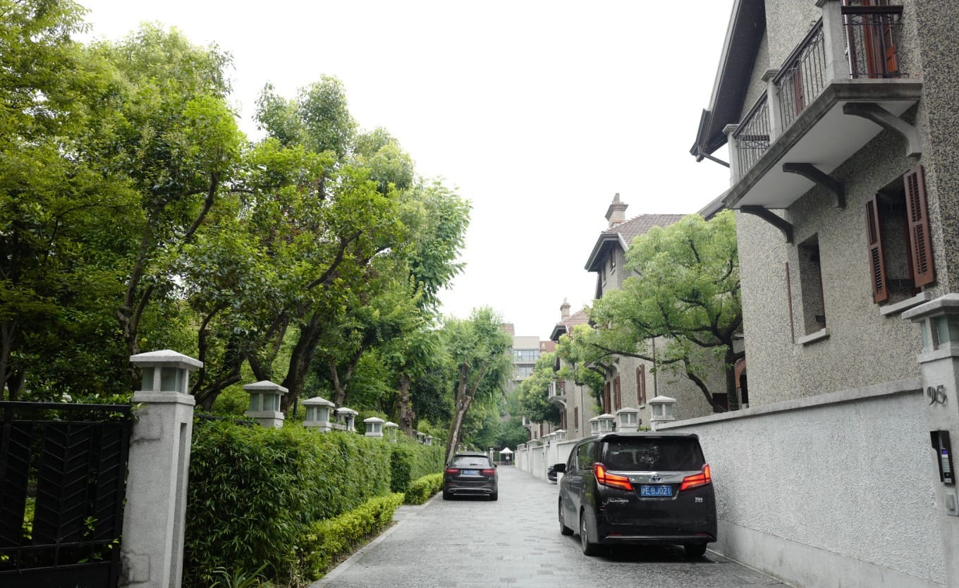 View through a gate into a private courtyard within the Sinan Mansions complex