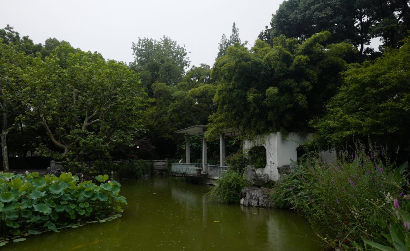 Traditional Chinese water-side pavilion and long corridor in Fuxing Park