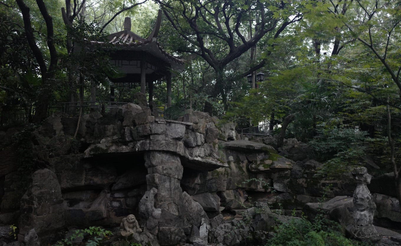 Artificial hill landscape with a small waterfall and an inaccessible pavilion in Fuxing Park