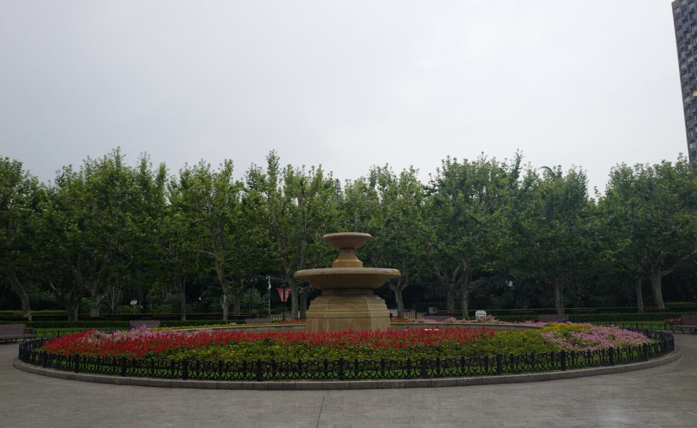 Wide path lined with trees showcasing the French-style landscaping within Fuxing Park