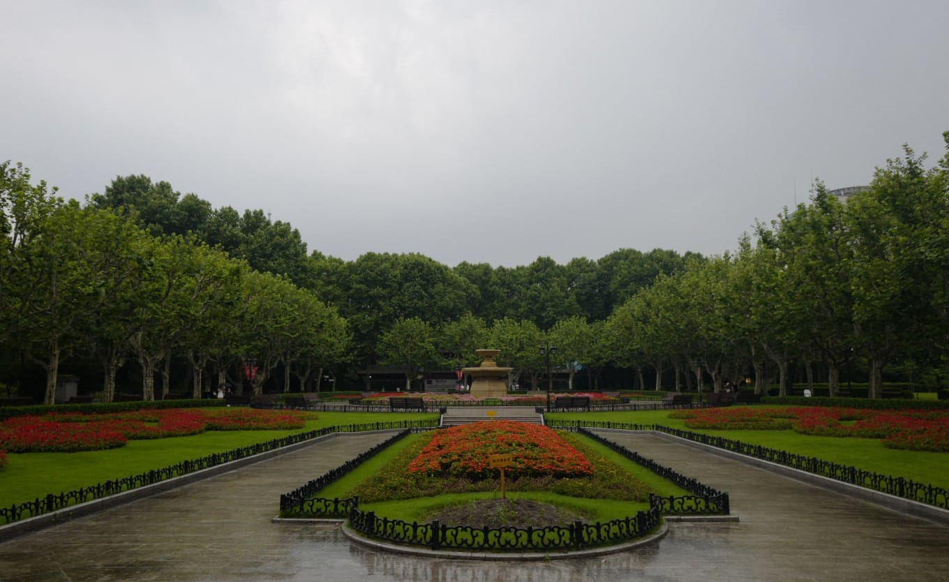 Tranquil garden scene with benches and lush greenery in Fuxing Park