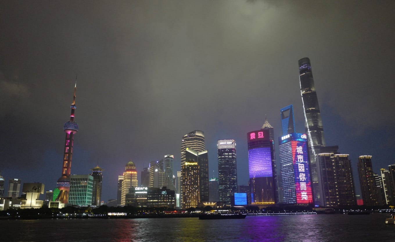 Pudong skyline at night with lit skyscrapers including the Shanghai Tower and Jin Mao Tower