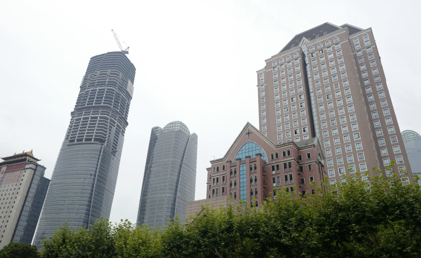 Construction site near the cathedral square, showing modern high-rises being built