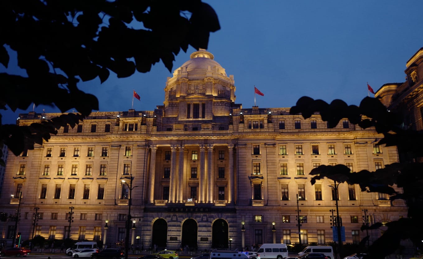 The Bund historic buildings illuminated at dusk with warm lighting