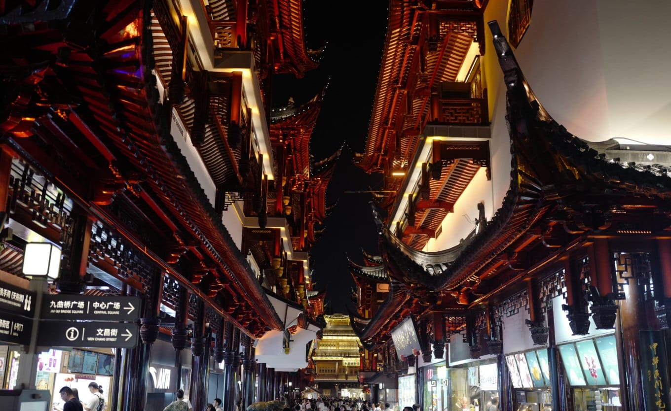 Chenghuangmiao Temple square illuminated by vibrant lights at night
