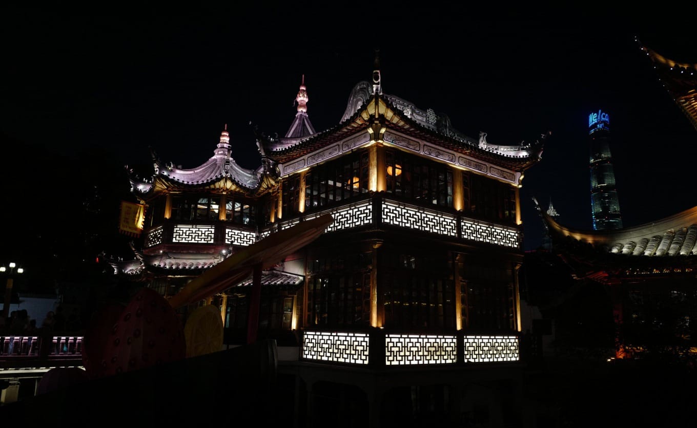 View of the Nine-Turn Bridge at Yuyuan Garden with reflections in water