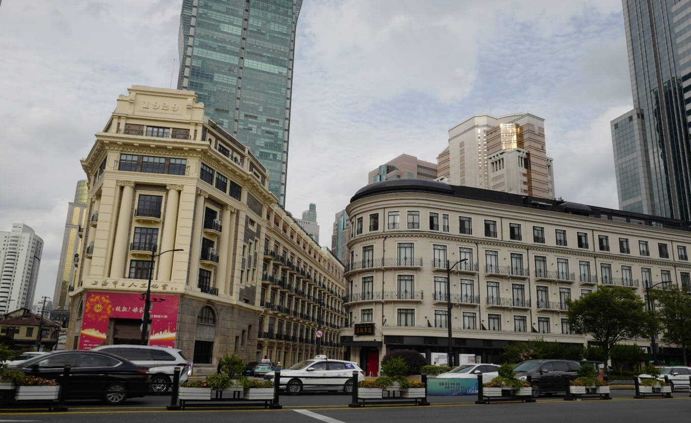 Exterior view of the historic Shanghai Workers' Cultural Palace building with dramatic cloud-filled sky