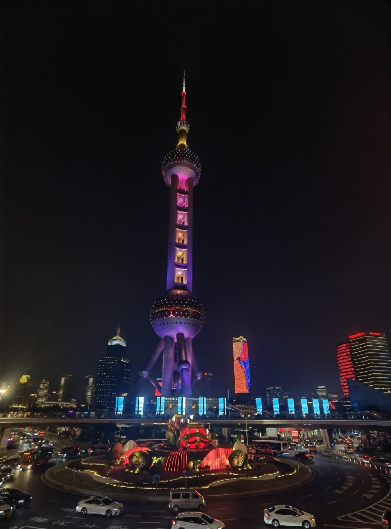 The Shanghai IFC Mall building with the Oriental Pearl Tower visible in the background