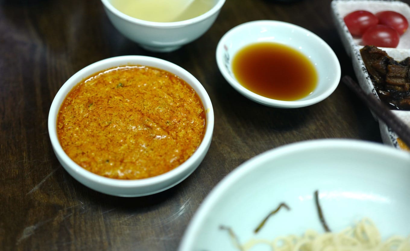 Chef preparing noodles in the kitchen at Yuxingji