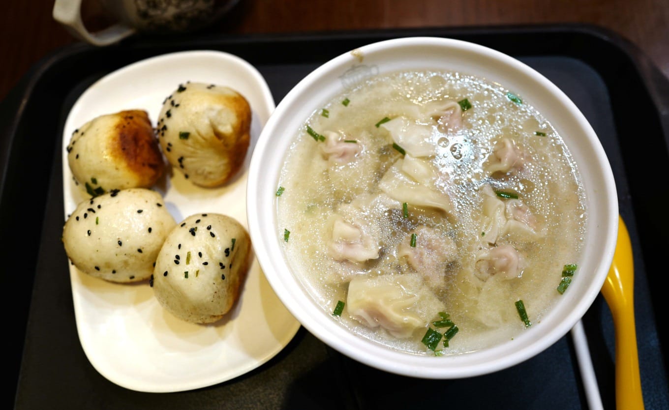 Close-up of pan-fried bun showing crispy bottom and juicy filling