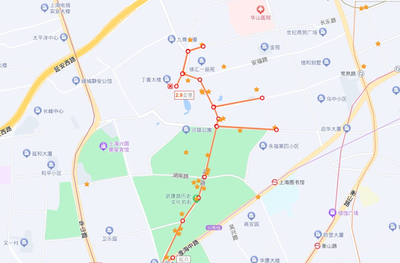 A quiet, tree-lined section of Wukang Road on a weekday