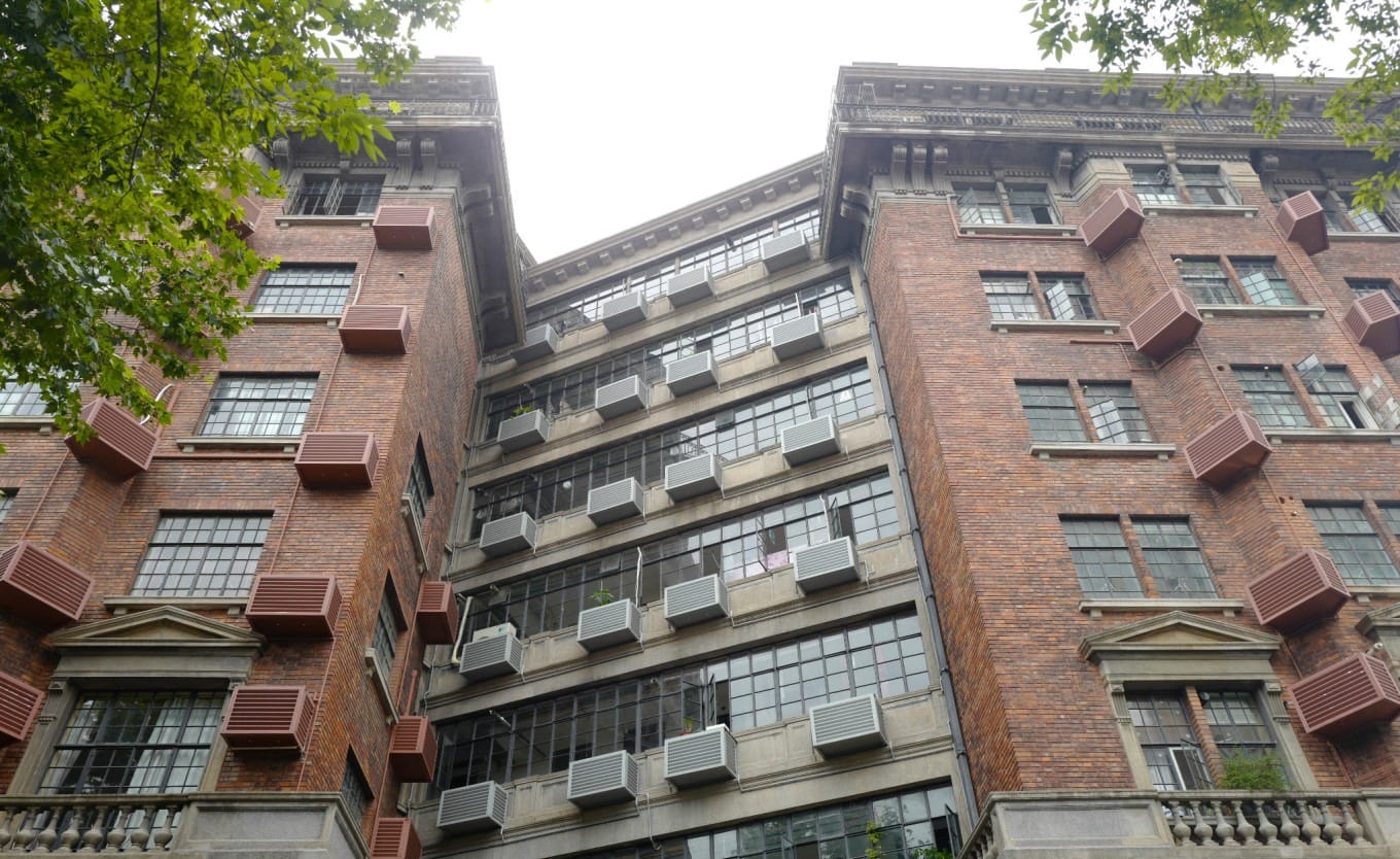 View of the Wukang Building's side, showing the uniform external boxes