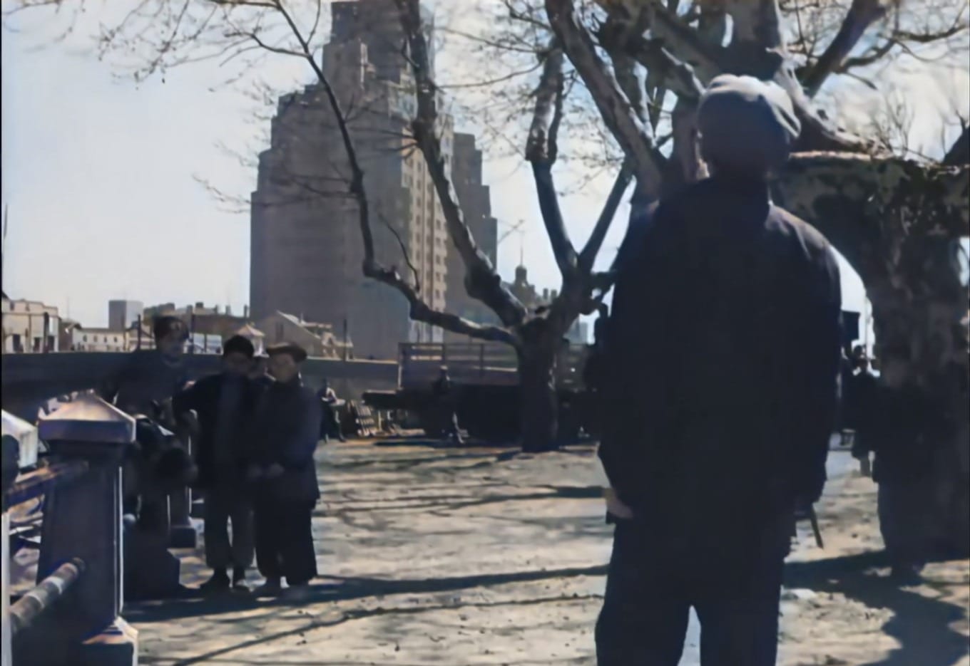 A still from the film San Mao's Ordeal showing the Shanghai Mansions across the river