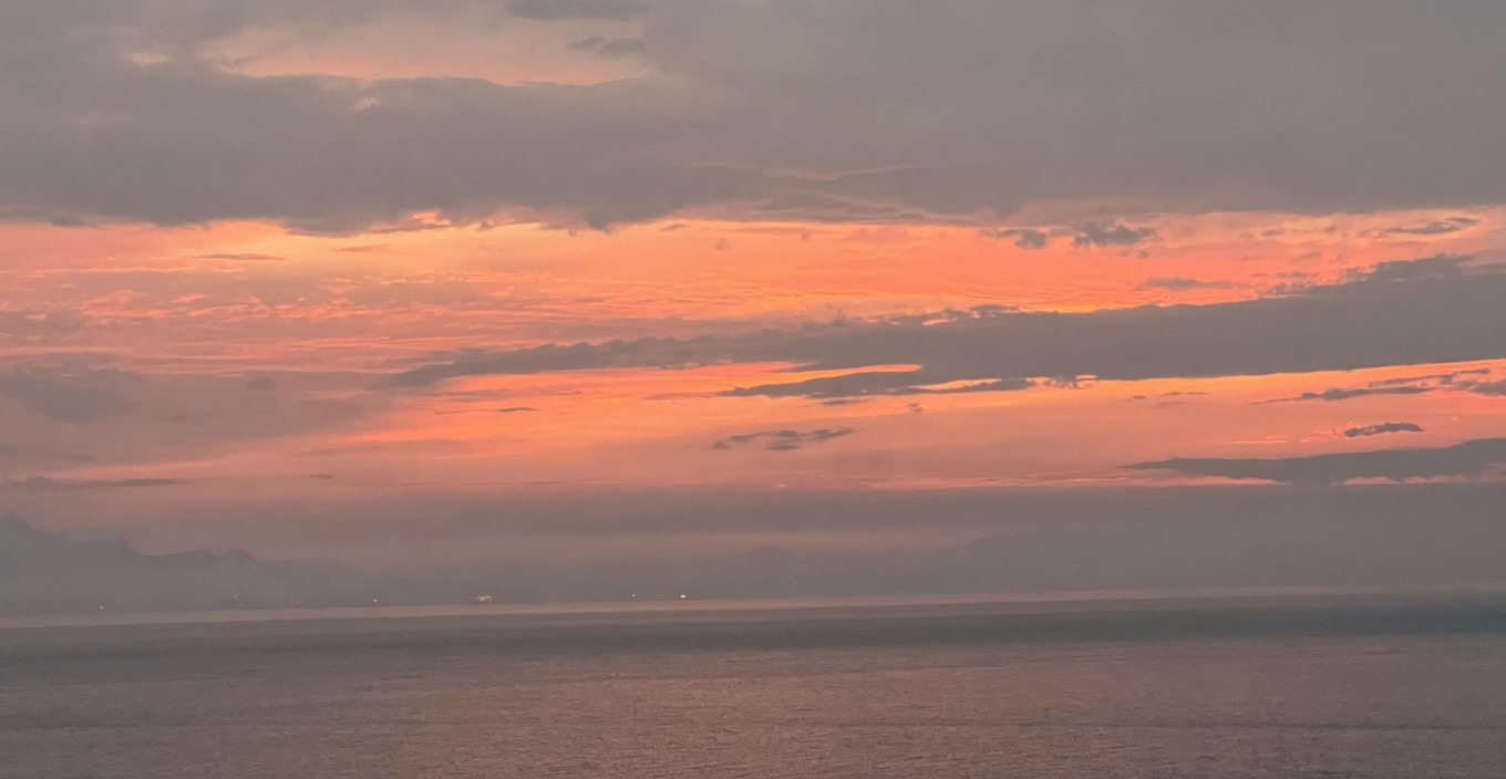 Sunset over the island's hills
