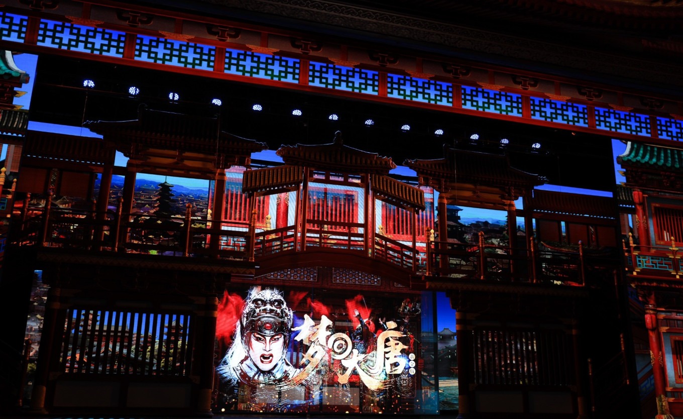 Golden palace stage with dancers in Tang dynasty costumes under colorful lights