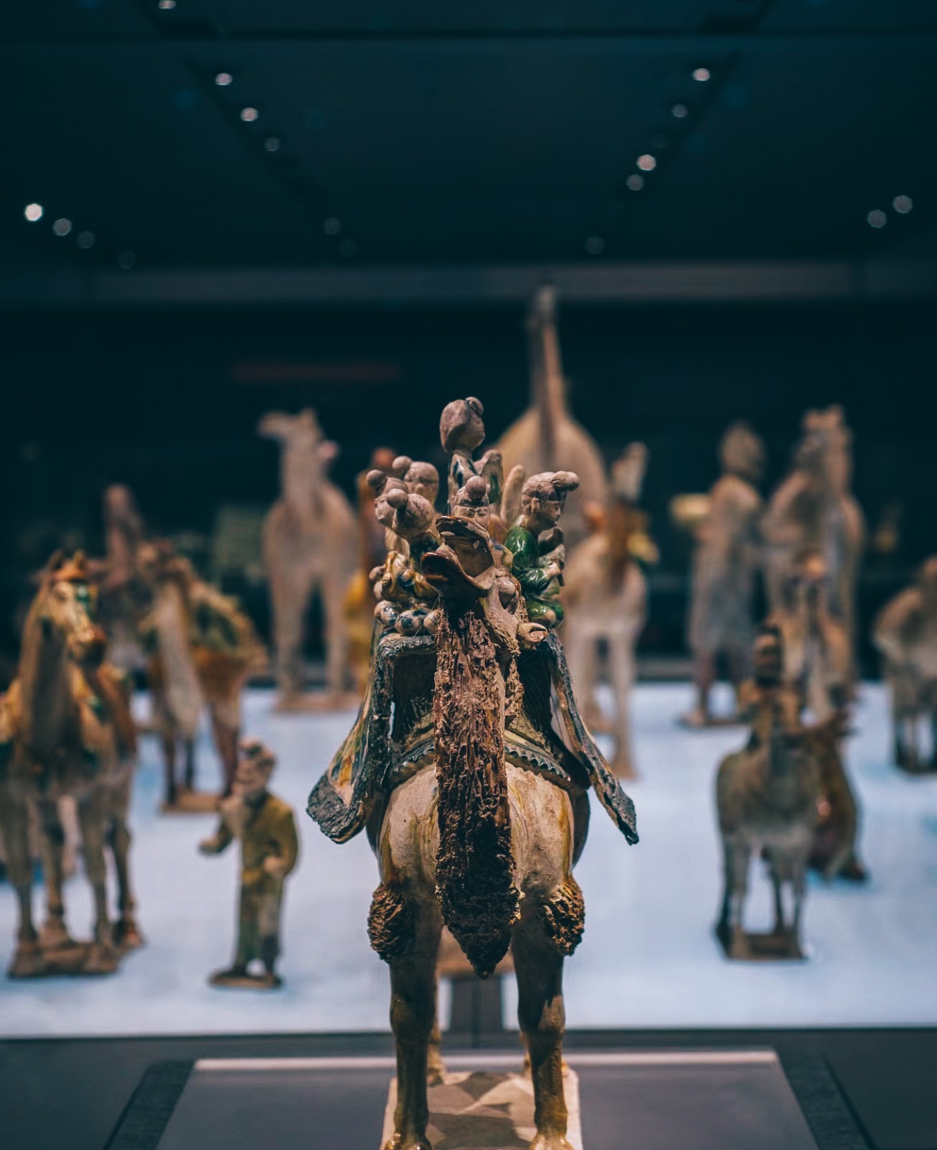 Tang dynasty tricolor glazed pottery camel with musicians and dancer