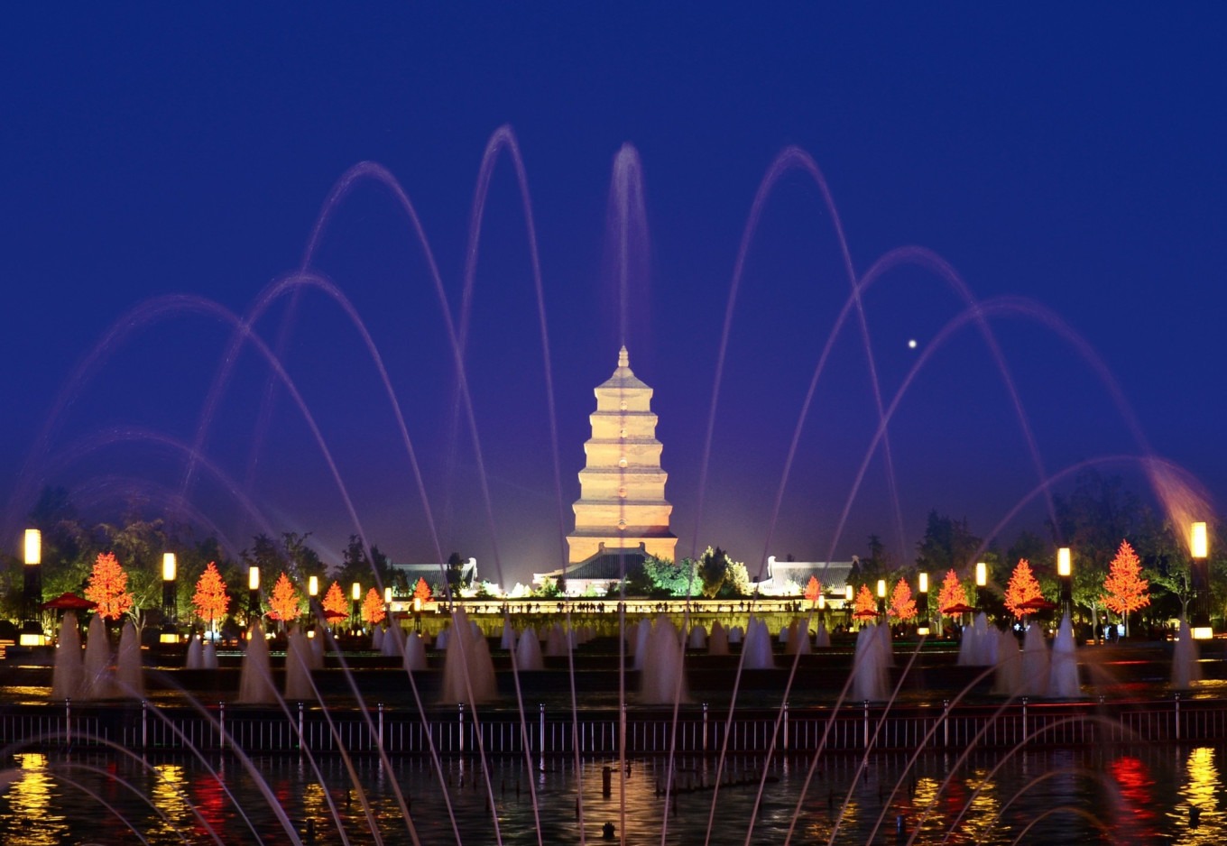 Night view of Big Wild Goose Pagoda with colorful lighting and reflection