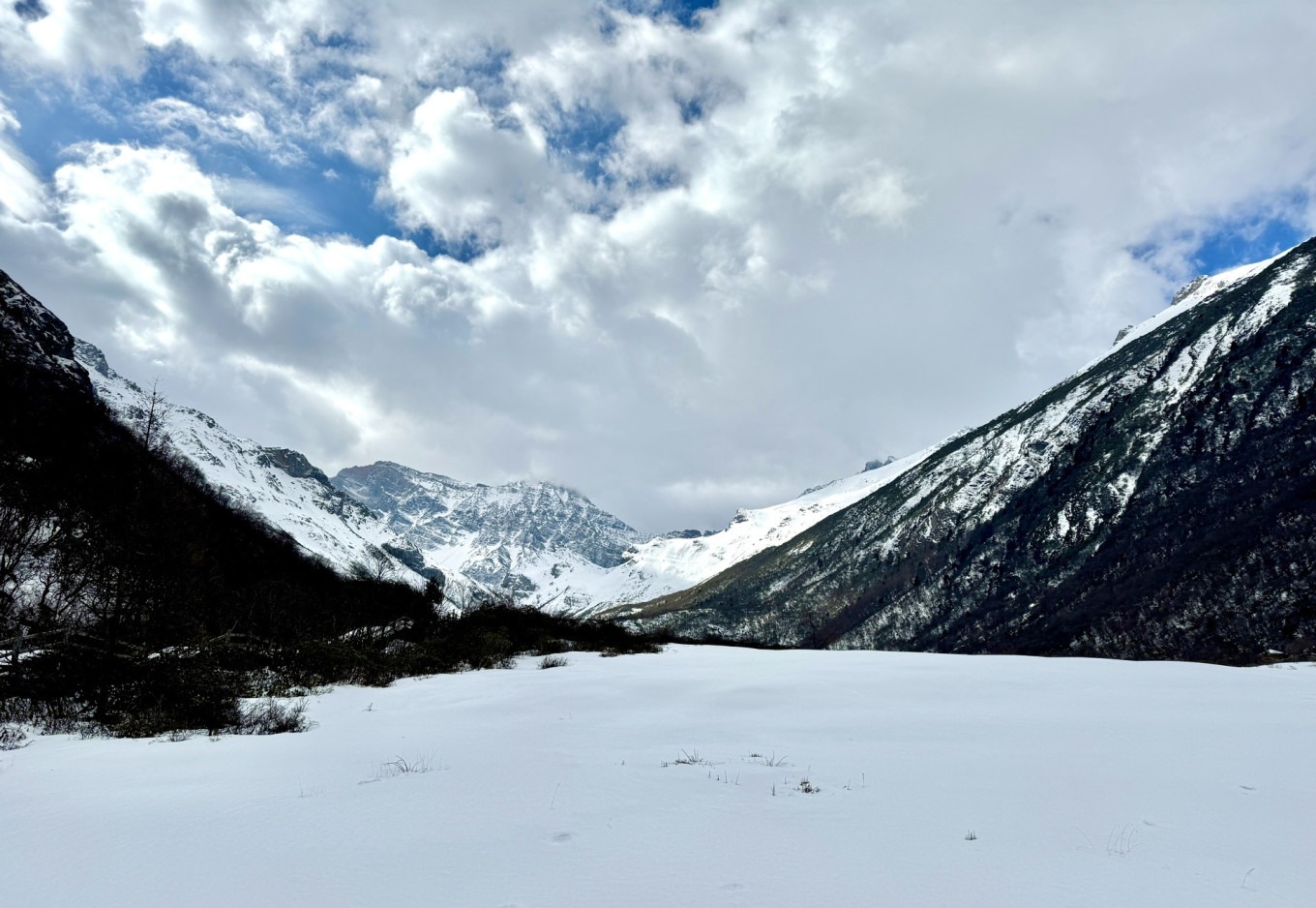 Colorful travertine pools of Wucai Chi in early spring with snow patches
