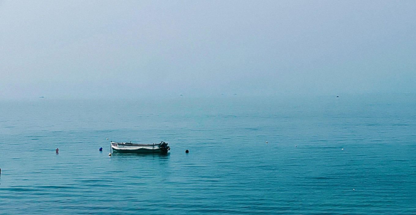 Panoramic view of Xiaomai Island's grassy hills and coastline