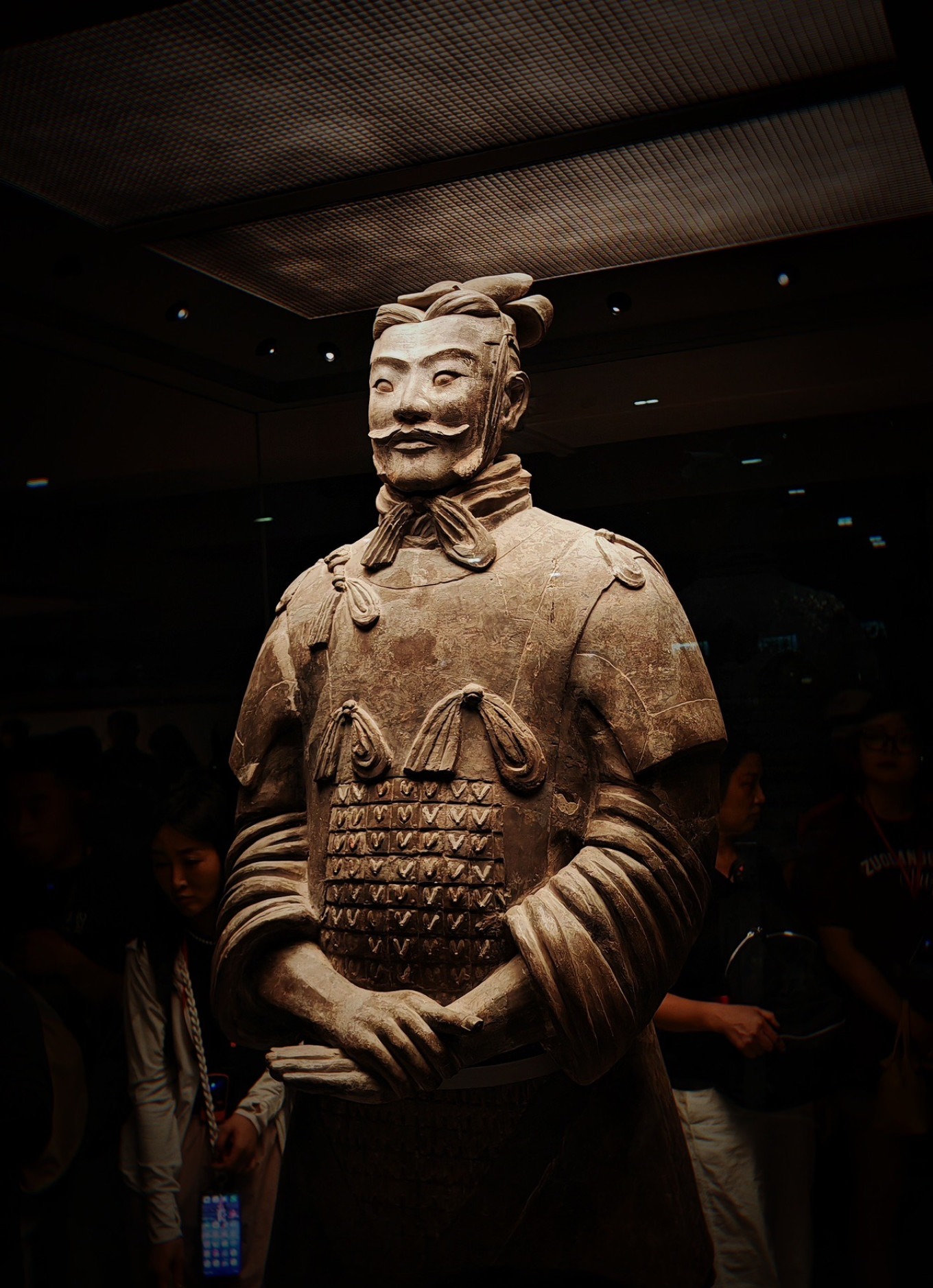 Close-up of a terracotta warrior showing detailed armor and facial features