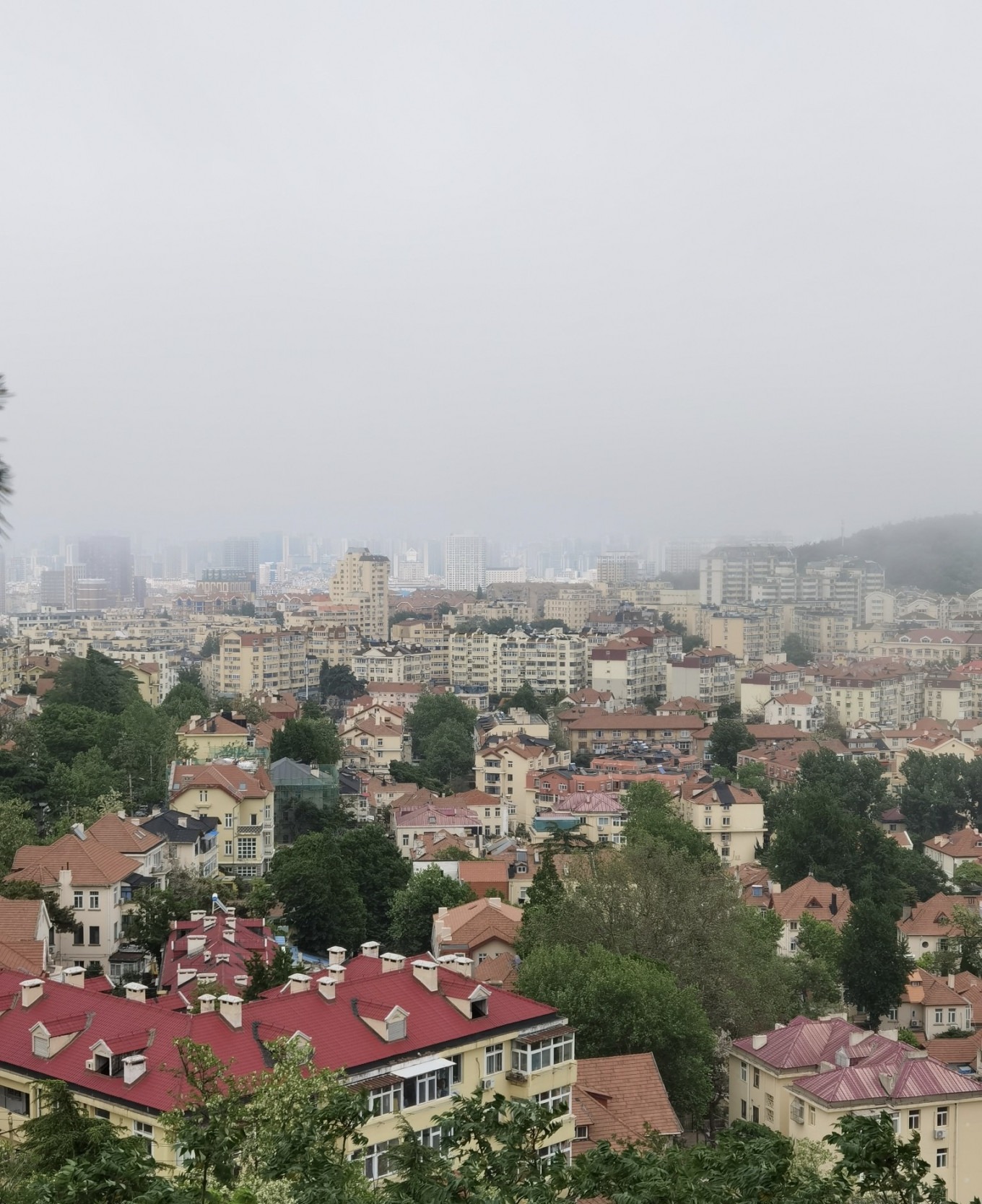 Foggy landscape of Qingdao with European-style architecture from Signal Hill