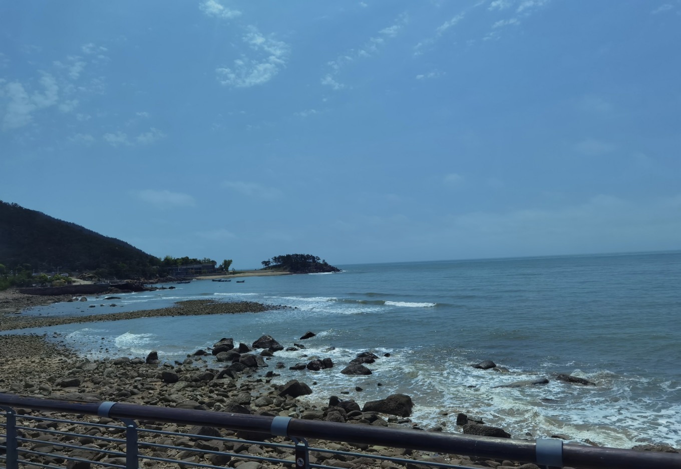 View from the shuttle bus showing the coastline and sea