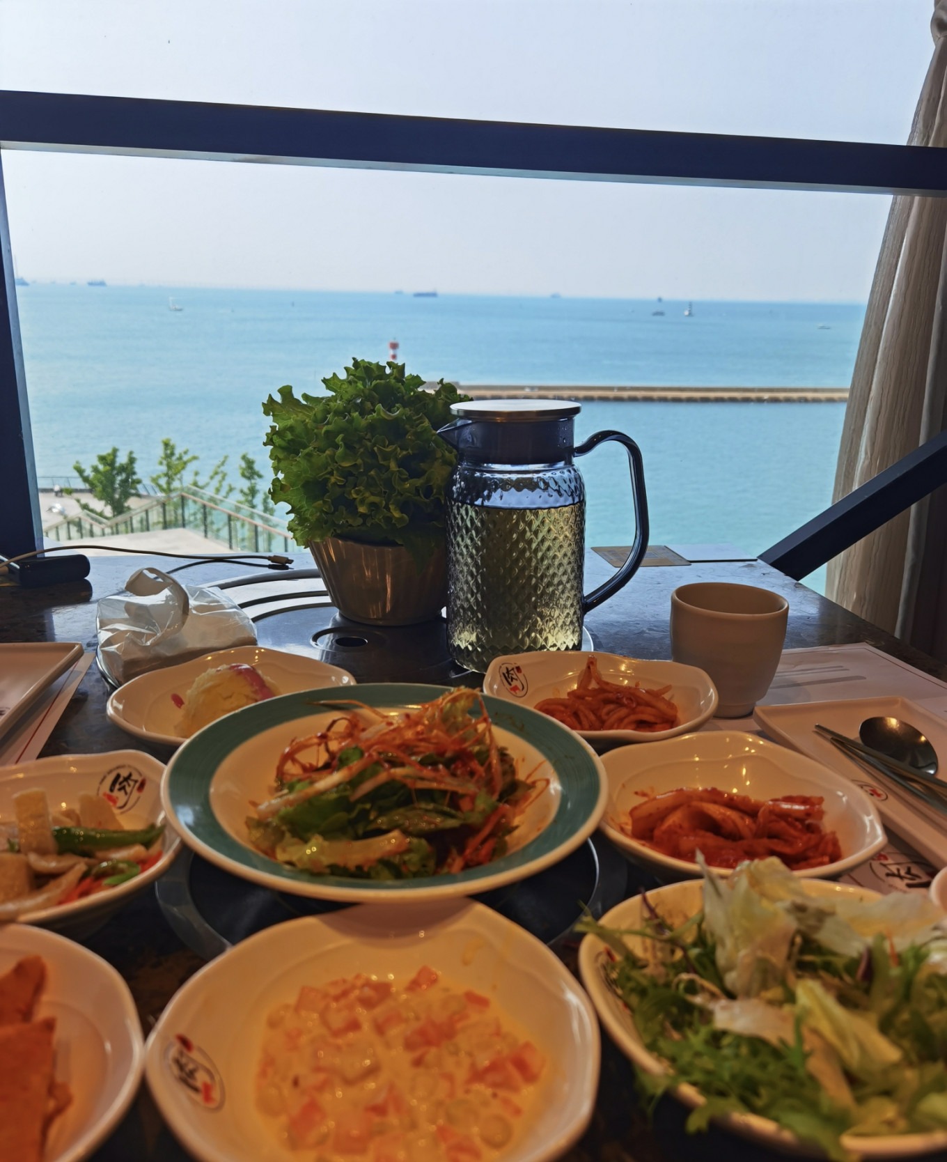 Seaside barbecue restaurant with view of lighthouse and fisherman