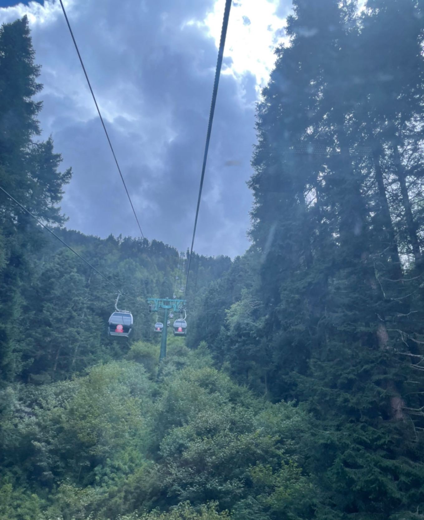 Uphill cable car at Huanglong with mountain views
